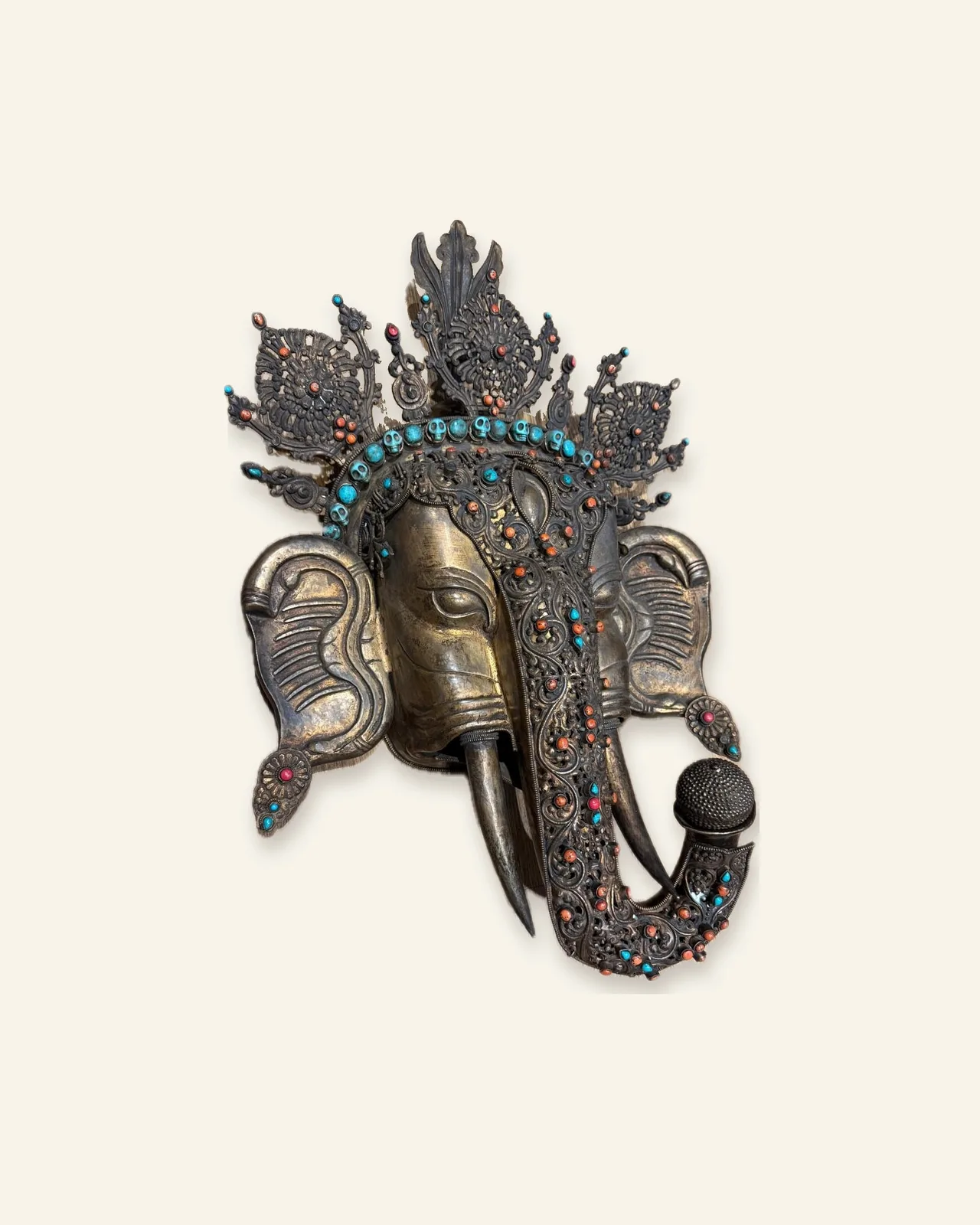Gilt copper mask of Ganesha, three-quarter view